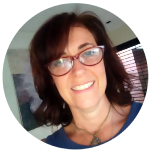 Female freelancer smiling with glasses.